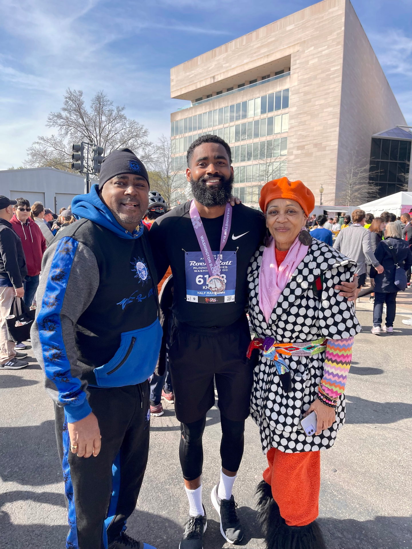Khalil celebrating after a race with parents